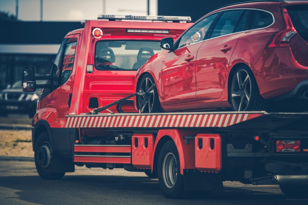Hinausauto hinaamassa punaista henkilöautoa